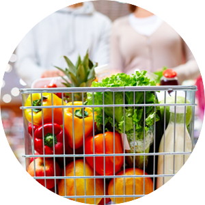 Grocery shopping cart filled with fresh produce. 