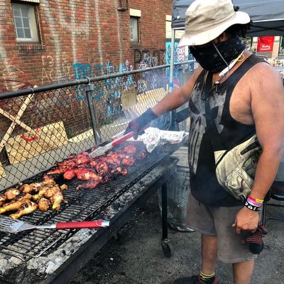 Bryant Jones cooking at a large grill outdoors.