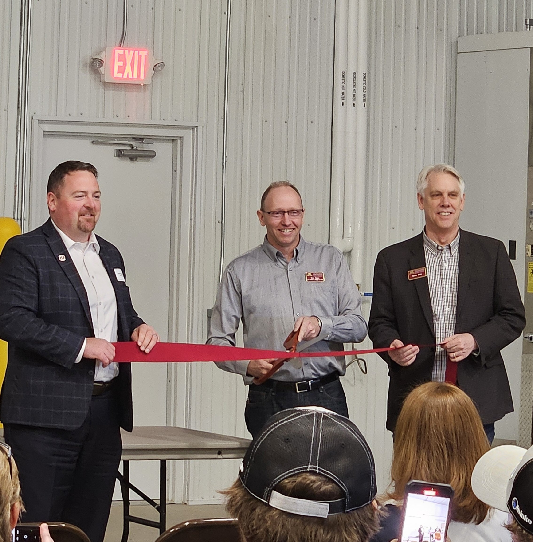 CFANS Dean Brian Buhr, SPRF Director Ron Faber, and Xcel Energy's John Marshall hold and cut a maroon ribbon during the grand opening event.