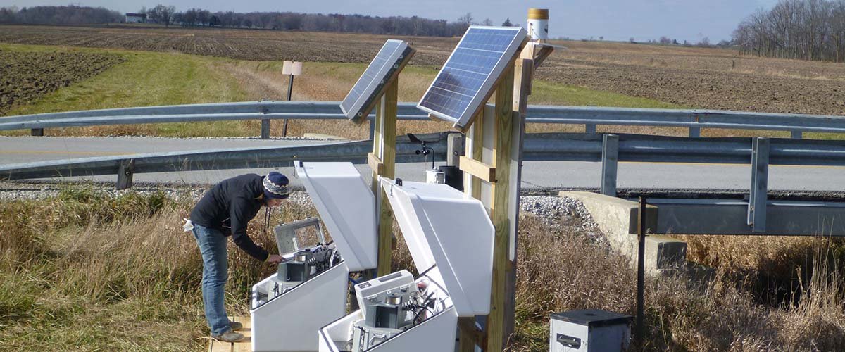 Programming an automated water sampler to capture phosphorus and nitrogen losses from a subsurface drainage system outlet. Photo by USDA-ARS.