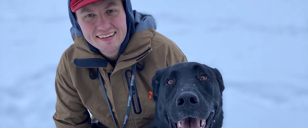 Sawyer Scherer with his black lab.