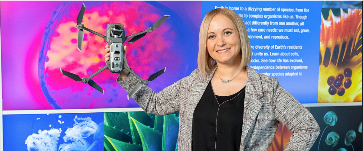 Magan Lewis holds a drone.