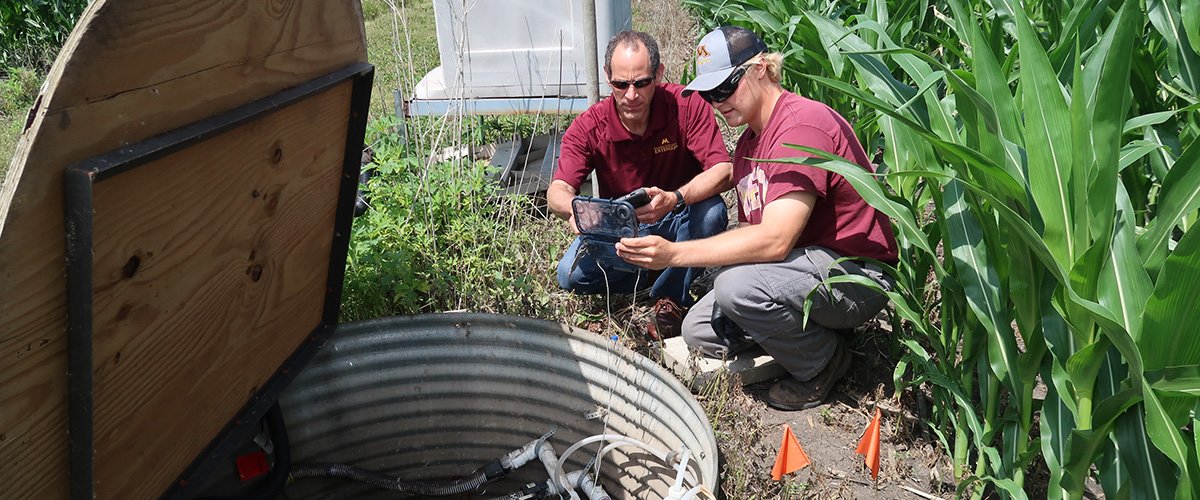 Fabian Fernandez and Zac Aanerud take a gas measurement next to a cornfield