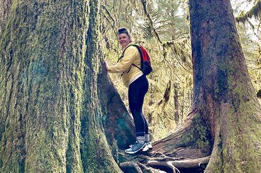 Kelly Martichuski hiking among the trees.