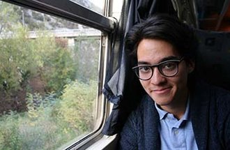 Applied economics alumnus Quentin IkutaSchodde on a train.