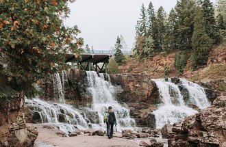 Person walking near Gooseberry Falls in Two Harbors, MN.