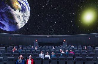 People watching show at Bell Museum Planetarium.