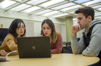 Applied Economics Professor Hikaru Peterson with students. 