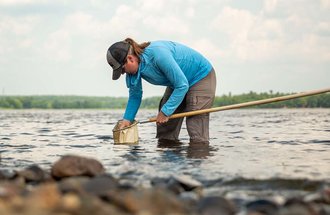 Researcher working in a lake. 