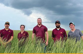 Forever Green team standing in a field. 